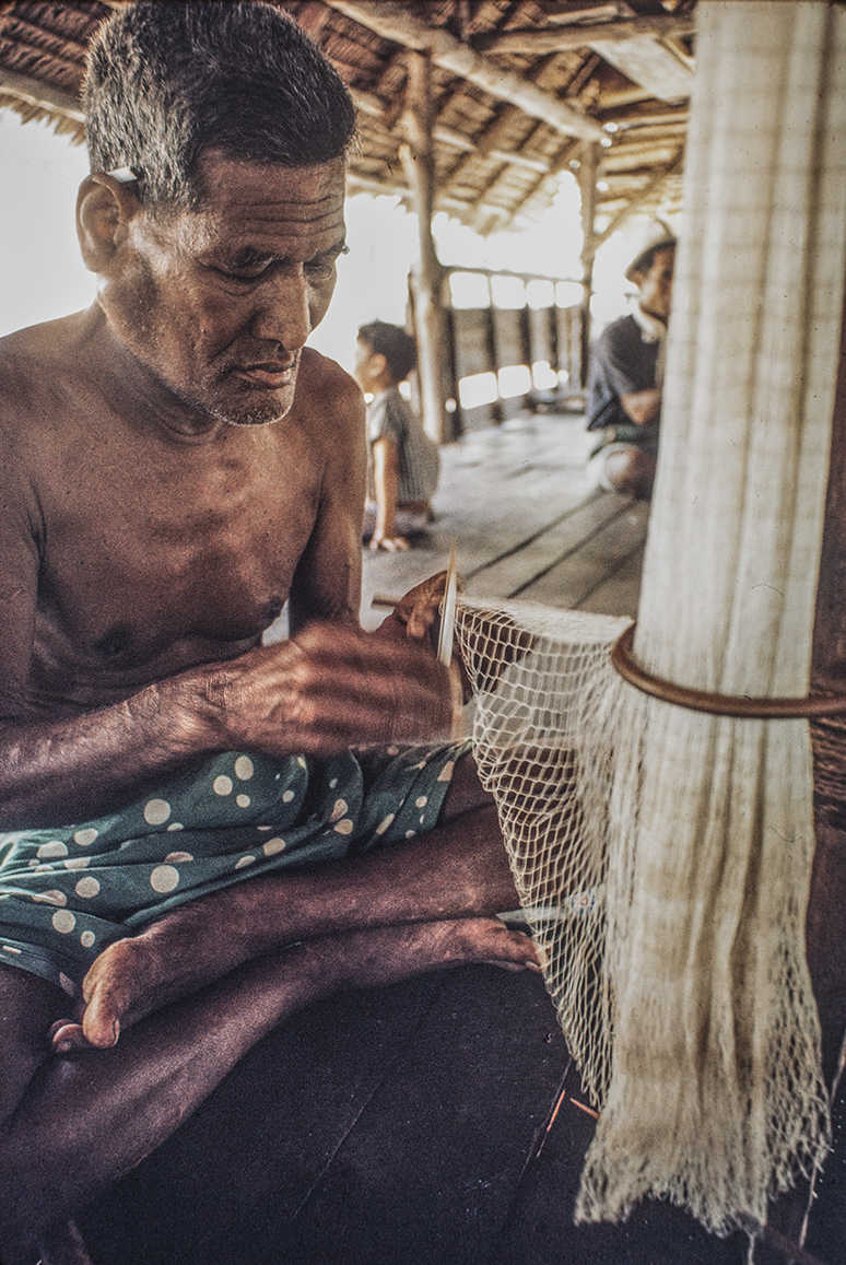 3153-2.jpg
Native fishermen in the "Mens House" working on net.  : Kapinga Fish Surround : Clayton Price Photographer